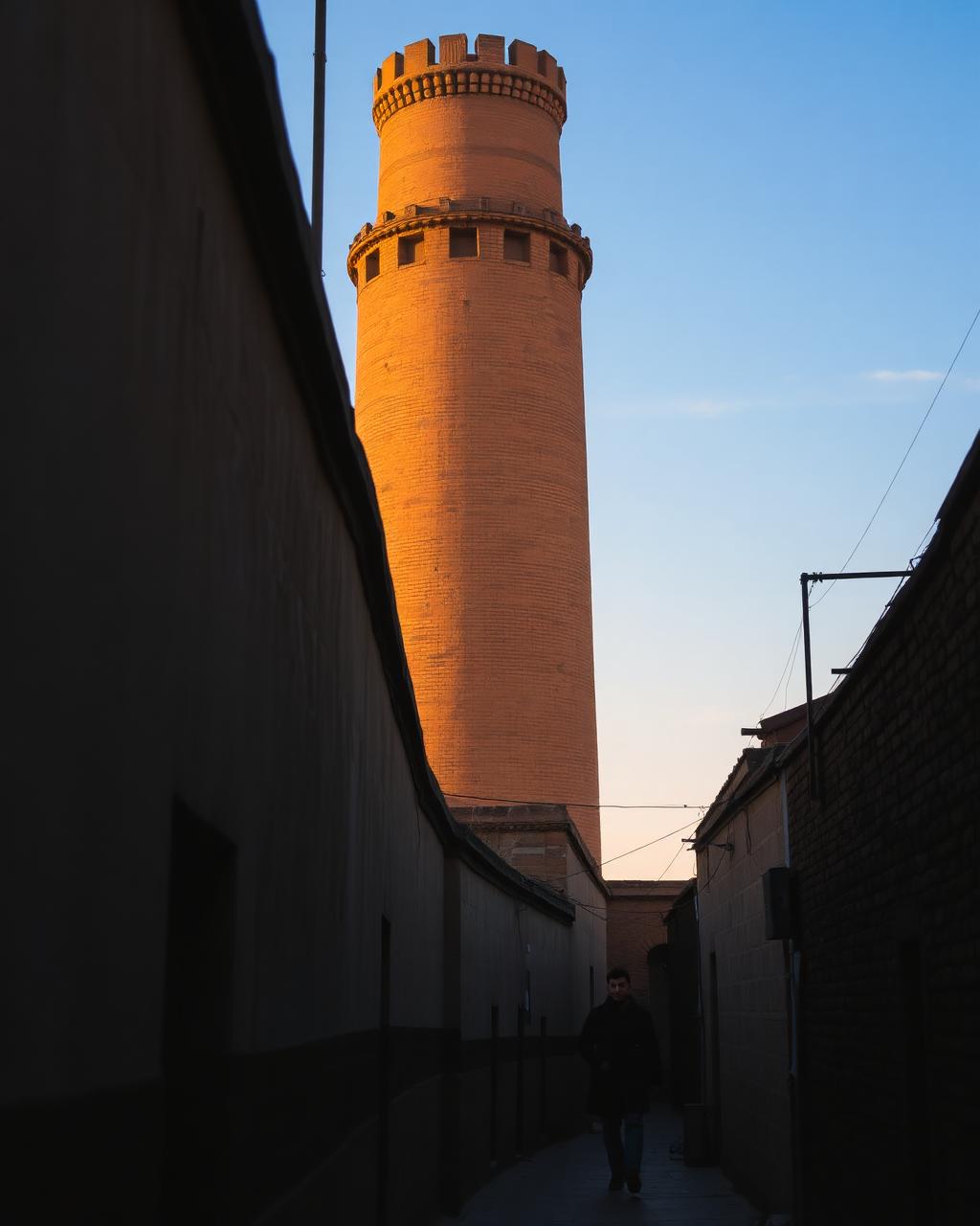 Old brick minaret above a Bukhara street